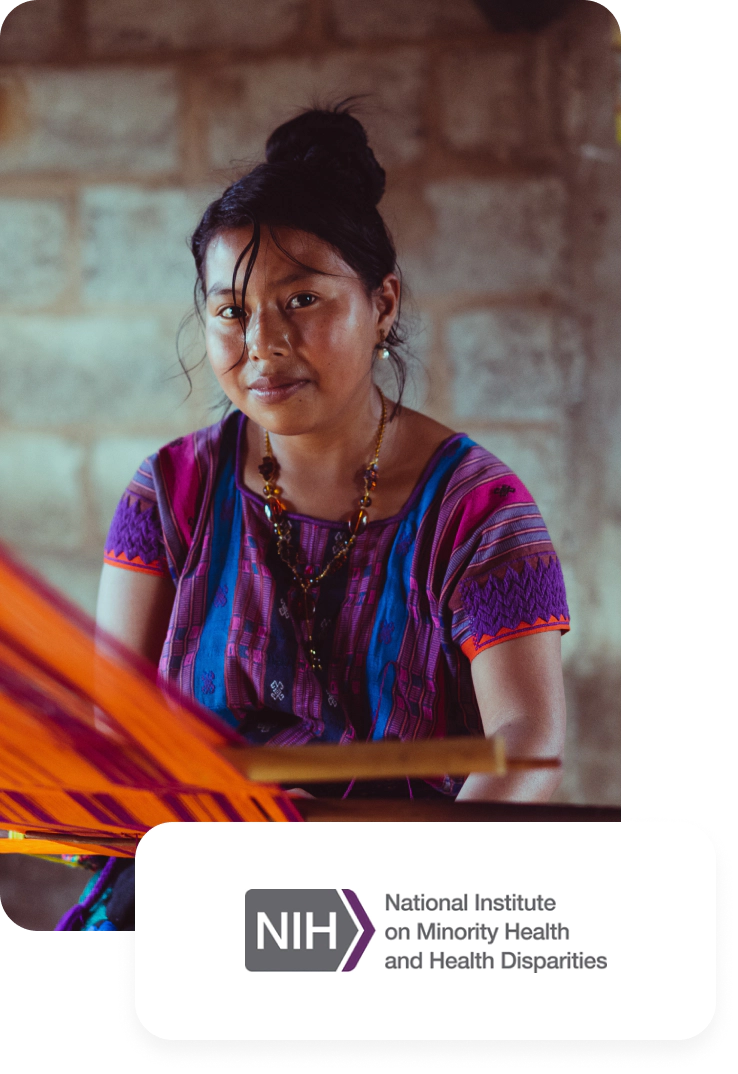 A woman dressed in traditional attire sits attentively before a loom, showcasing her craft. On her wrist, she proudly wears a SENSR fitness tracker. The National Institute on Minority Health and Health Disparities logo is prominently displayed in the lower right corner, highlighting the organization's commitment to community health and wellness.